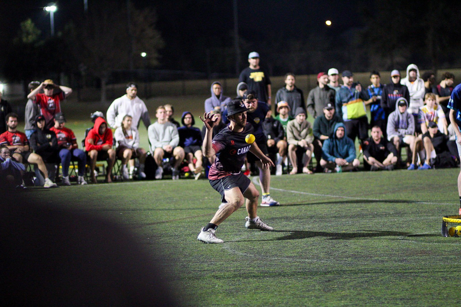 A finals match under the lights, crowd watching